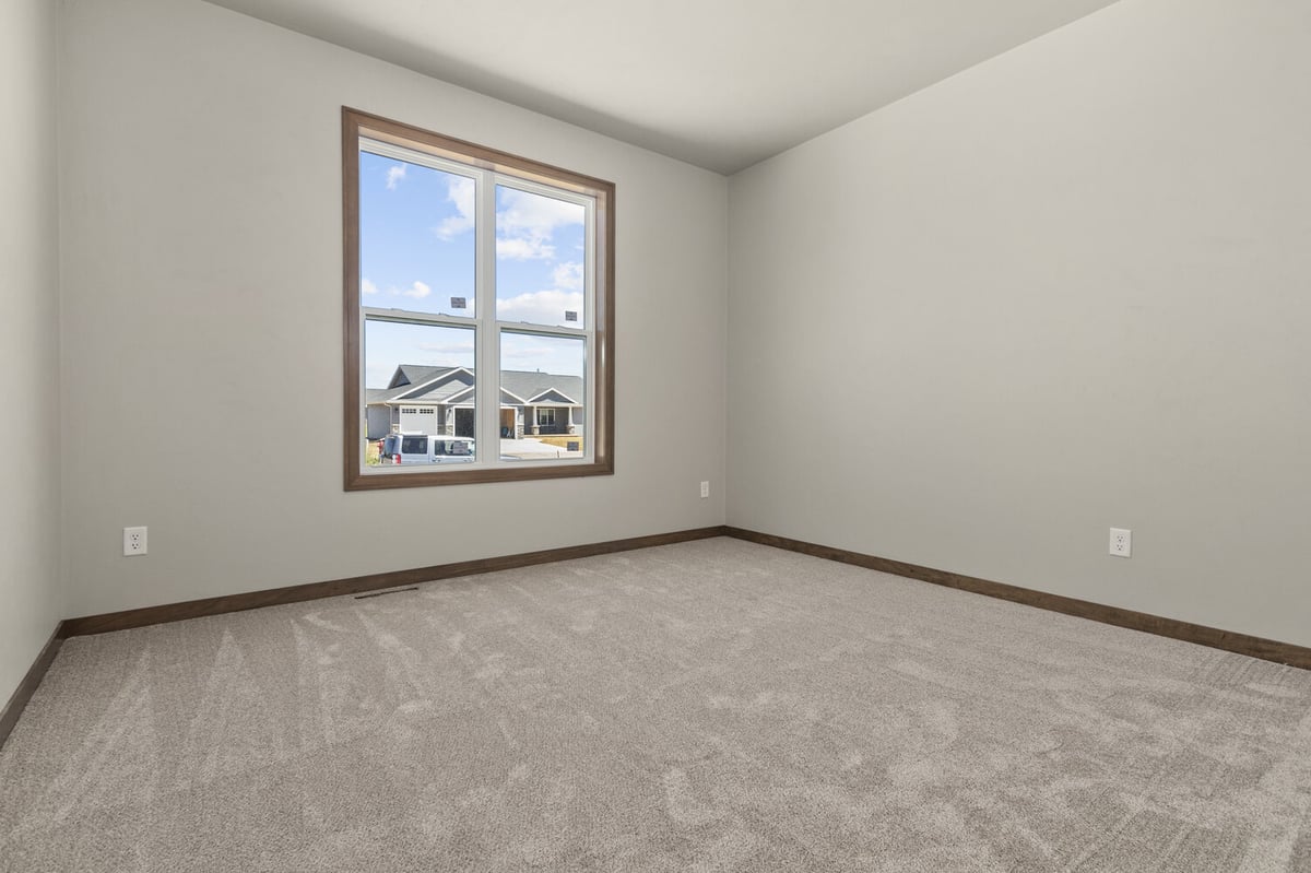 Cozy neutral-toned bedroom in new home construction by Midwest Design Homes in Appleton, WI