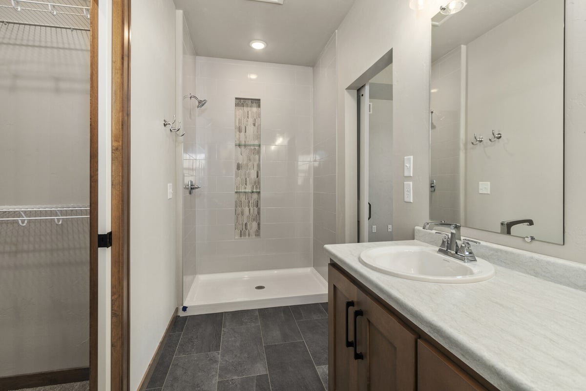 Modern bathroom with walk-in tile shower by Midwest Design Homes in Fox Cities, WI