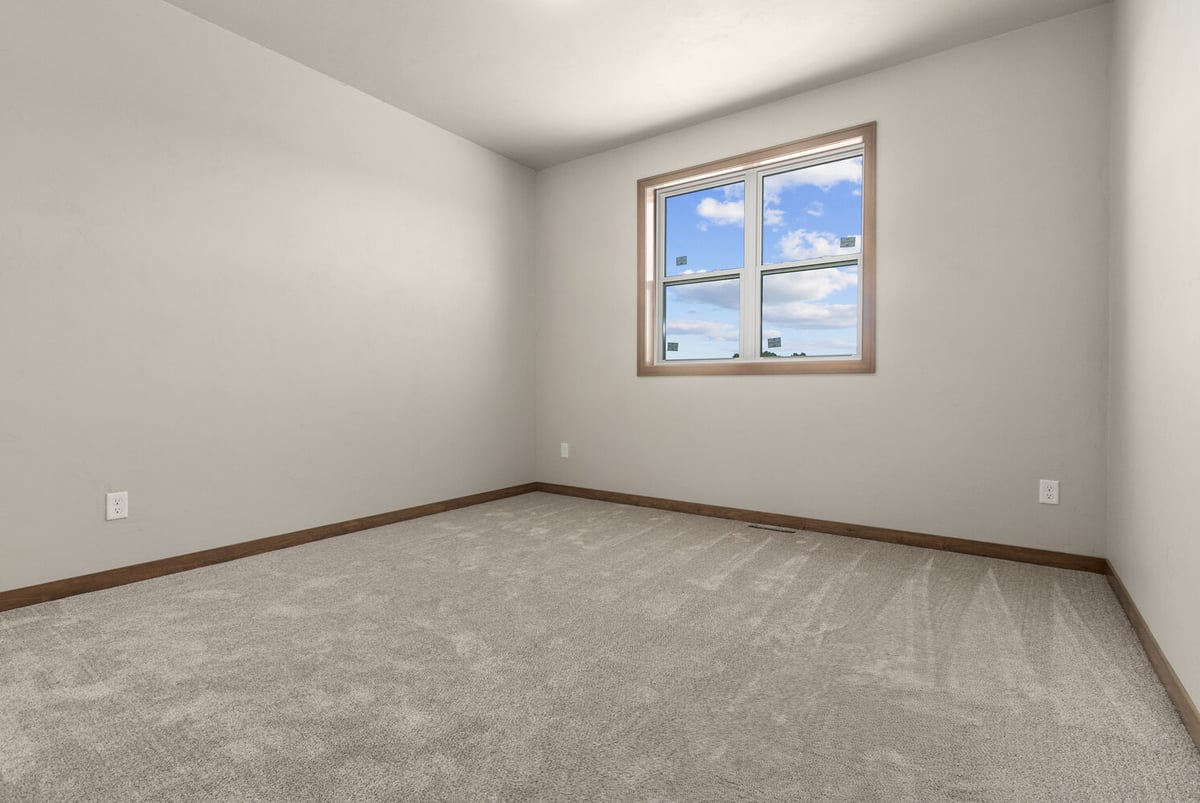 Natural light in compact bedroom of custom home in Greenville, WI by Midwest Design Homes