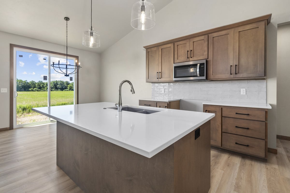 Open-concept kitchen with built-in microwave in Fox Cities home by Midwest Design Homes