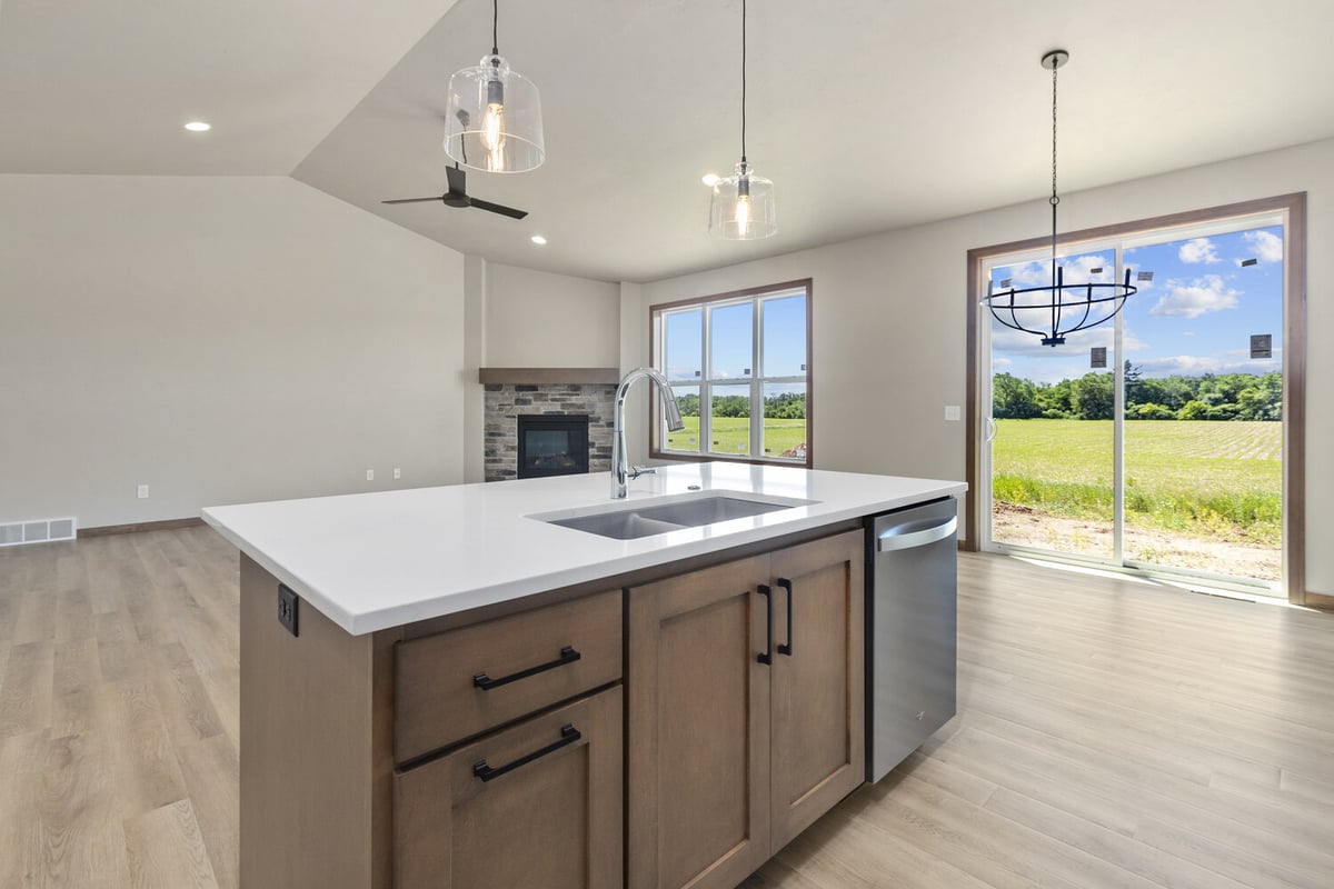 Quartz island with stainless sink in custom-built home near Appleton WI by Midwest Design Home