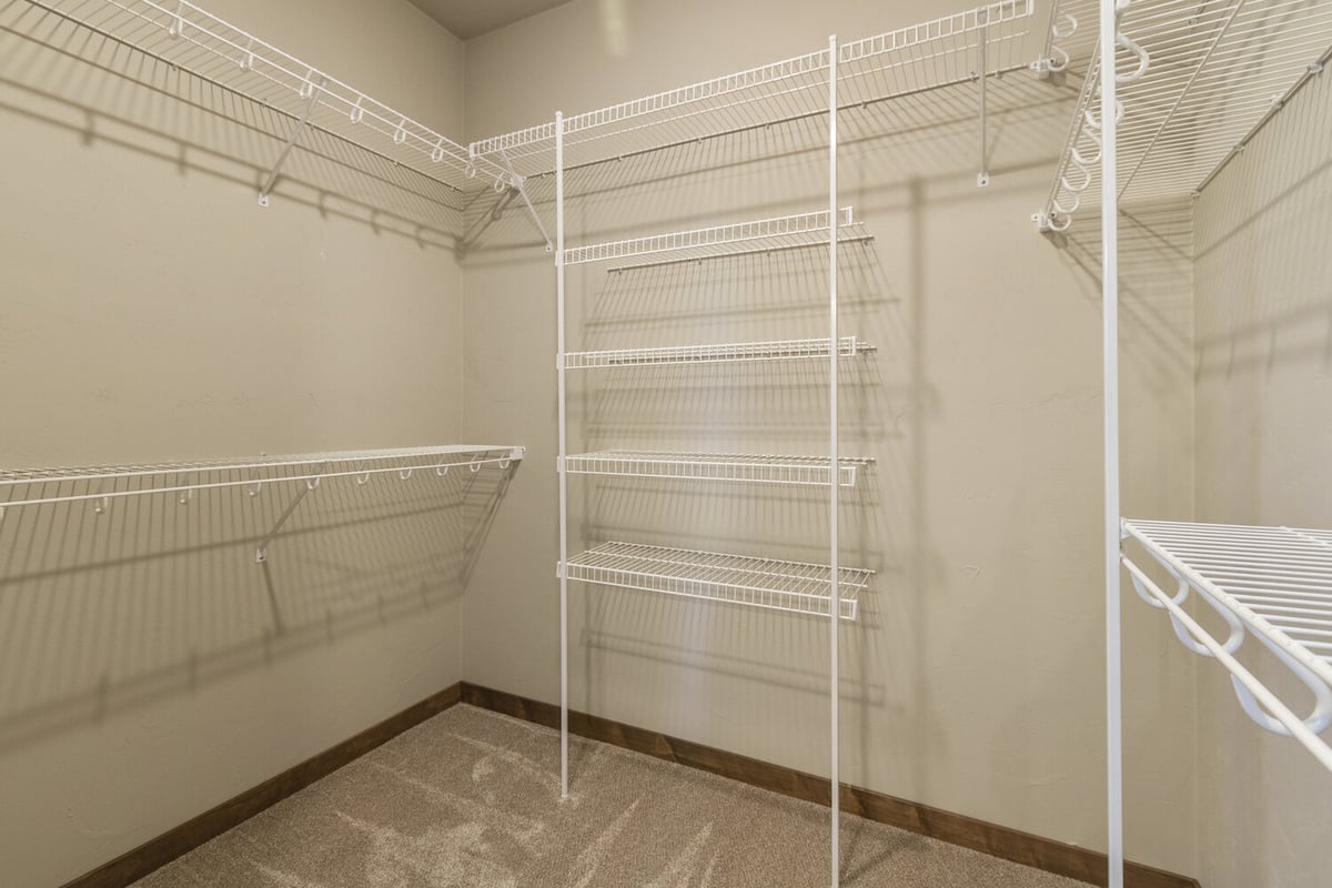 Walk-in closet with white wire shelving in custom home by Midwest Design Homes in Kaukauna, WI