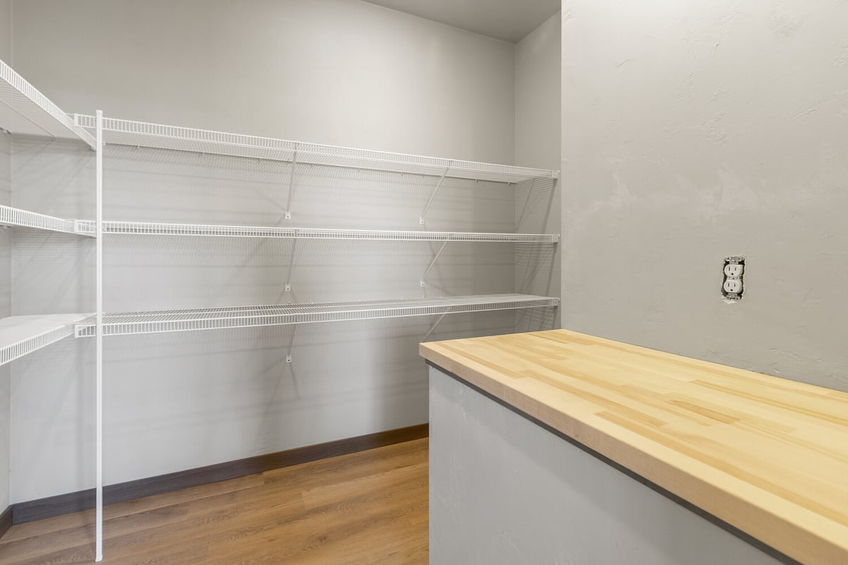 Walk-in pantry with open shelving in custom home by Midwest Design Homes in Kaukauna, WI