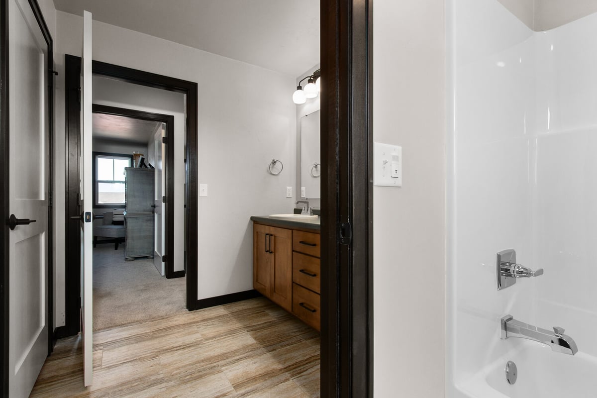 Bathroom entrance with a view of vanity and shower in a custom home by Midwest Design Homes