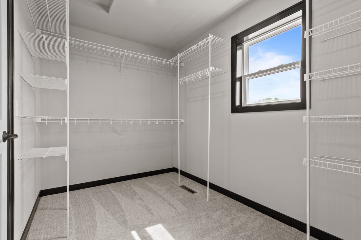 Bright custom closet space with wire racks in Wisconsin home by Midwest Design Homes