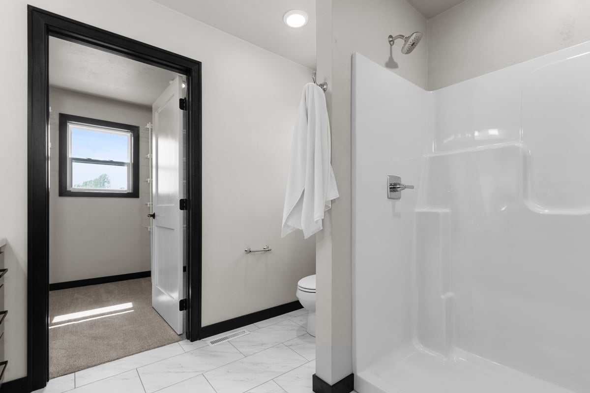 Custom bathroom with white shower and modern finishes by Midwest Design Homes in Kaukauna, WI