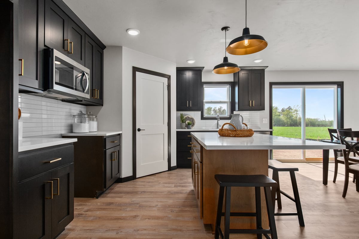 Kitchen island and open layout in Kaukauna custom home by Midwest Design Homes