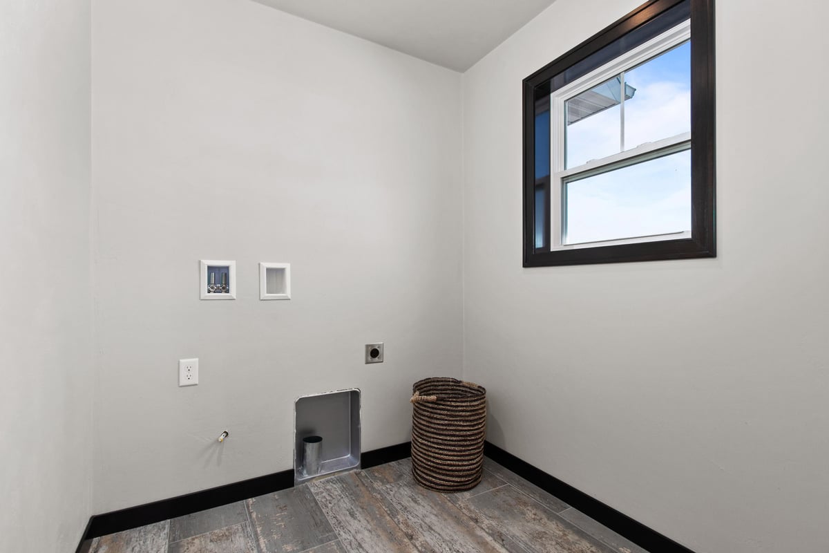 Laundry room with window in custom home by Midwest Design Homes in Fox Cities, WI