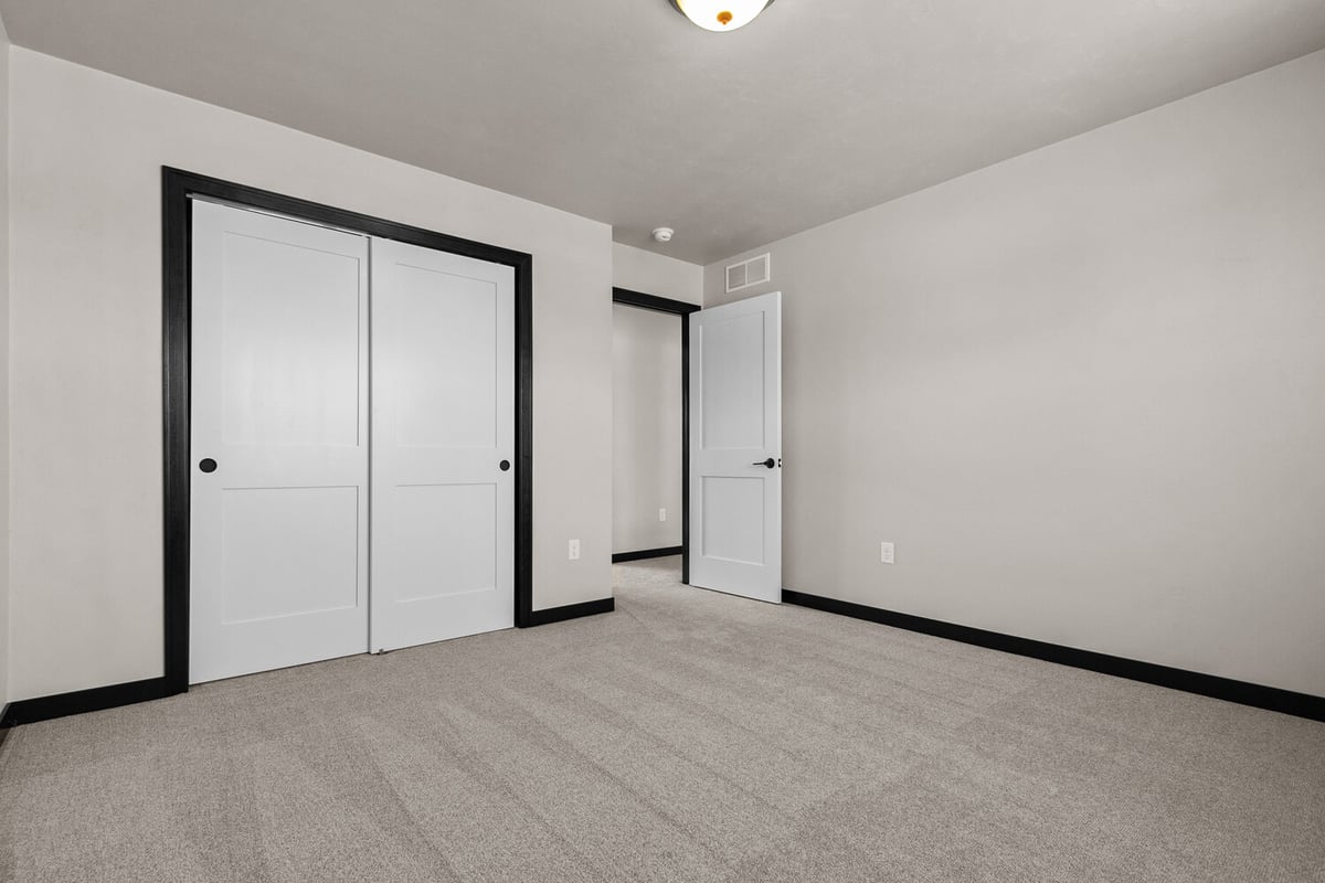 Midwest Design Homes bedroom interior with clean design and ample storage in the Fox Cities