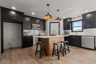 Sleek kitchen design with pendant lighting by Midwest Design Homes in WI