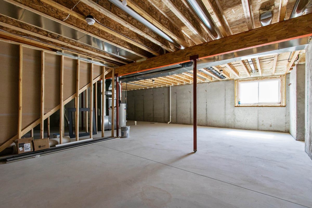 Wide view of a concrete basement floor in a Wisconsin custom home by Midwest Design Homes