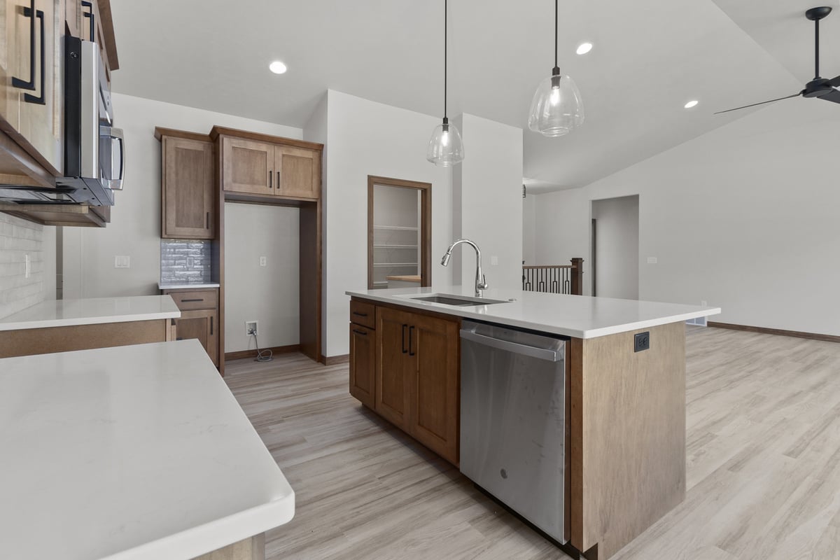 Custom kitchen with walk-in pantry in Fox Cities home by Midwest Design Homes