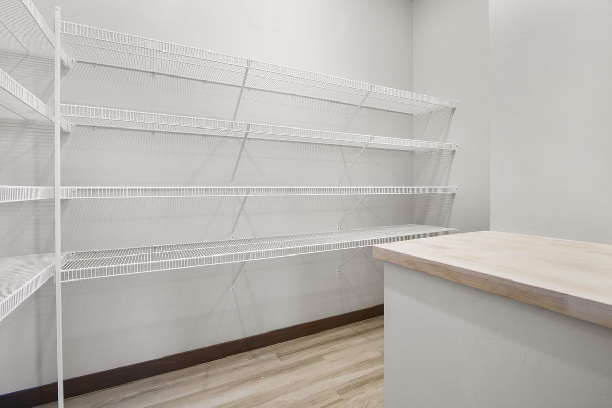 Custom pantry with shelving in Wisconsin home by Midwest Design Homes