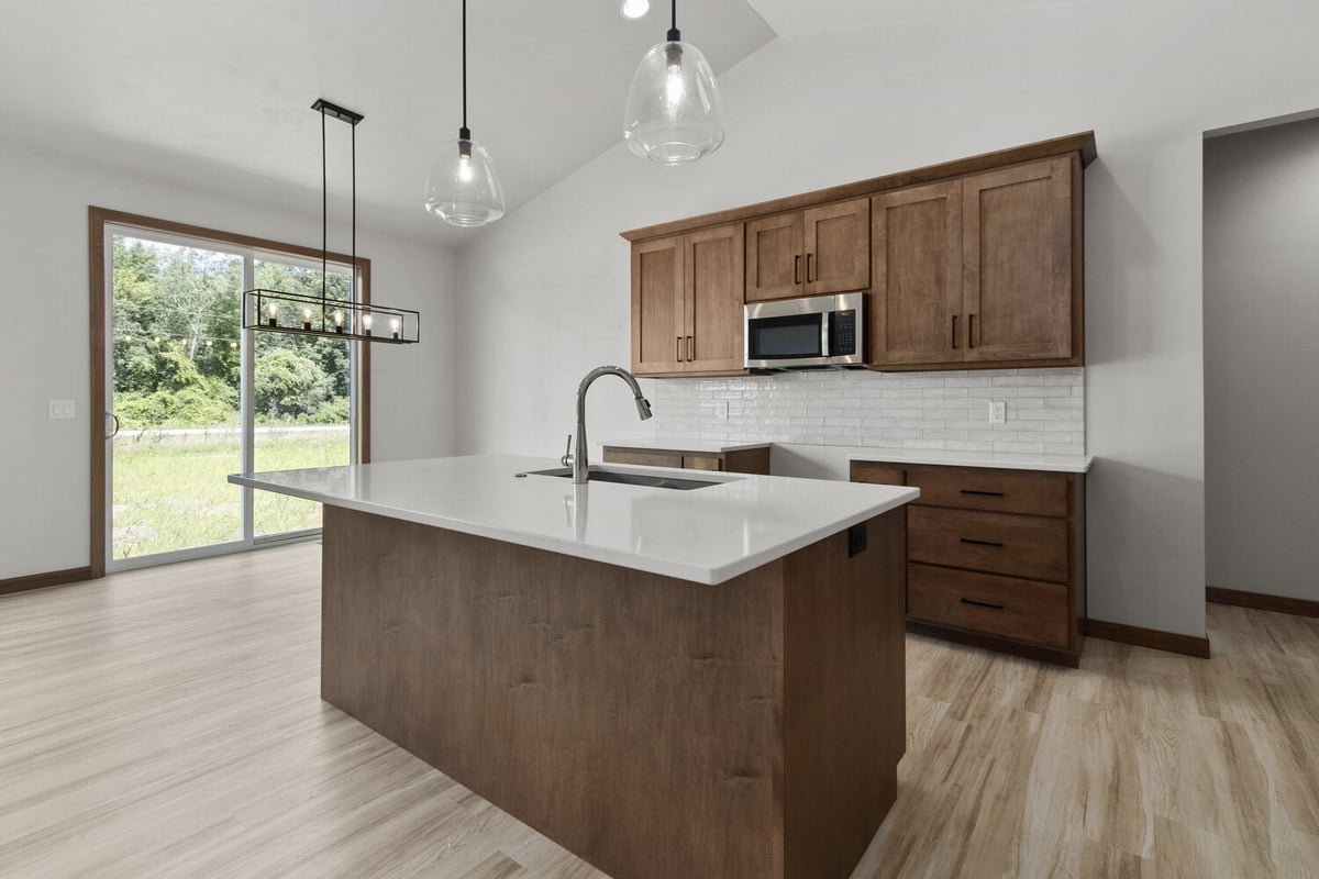 Kitchen island with pendant lights in Fox Cities home by Midwest Design Homes