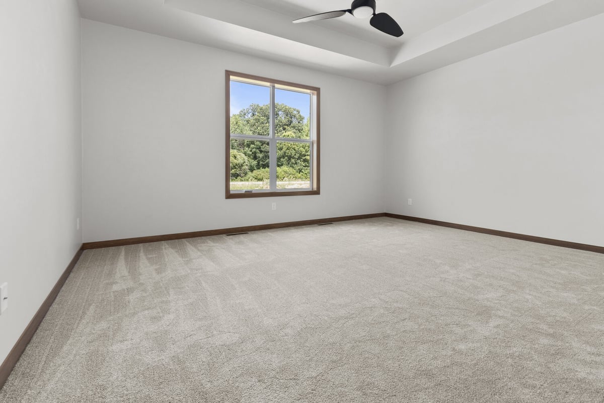 Large master bedroom with window in Green Bay WI by Midwest Design Homes