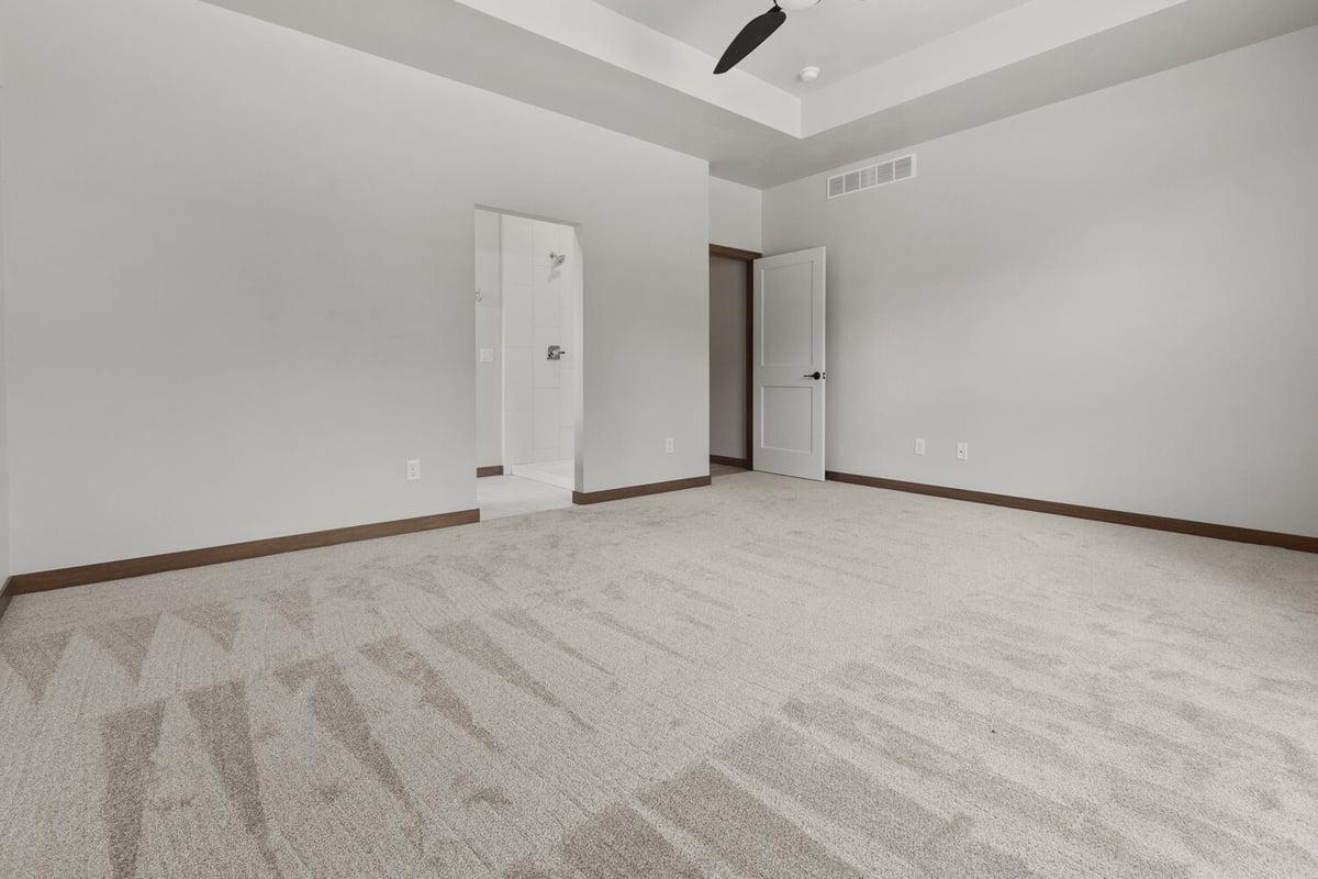 Master bedroom with en suite bath in Fox Cities WI custom home by Midwest Design Homes