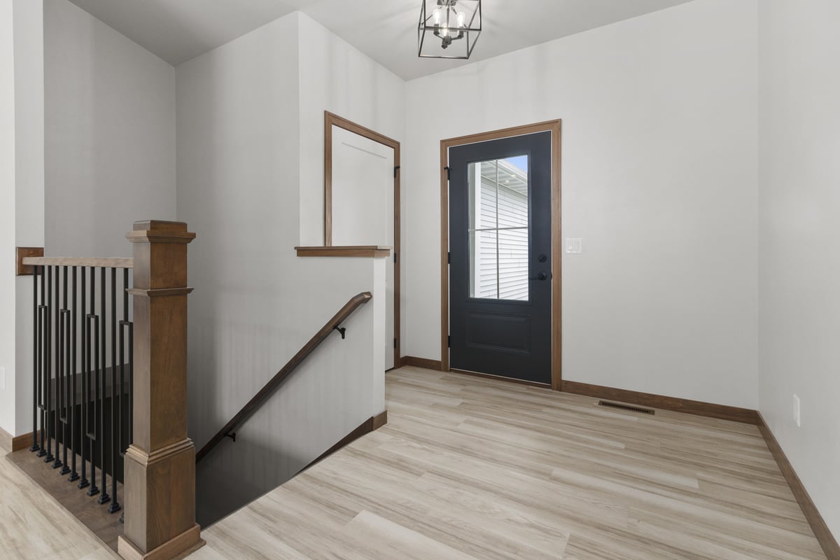 Midwest Design Homes Wisconsin custom foyer with staircase and wood trim
