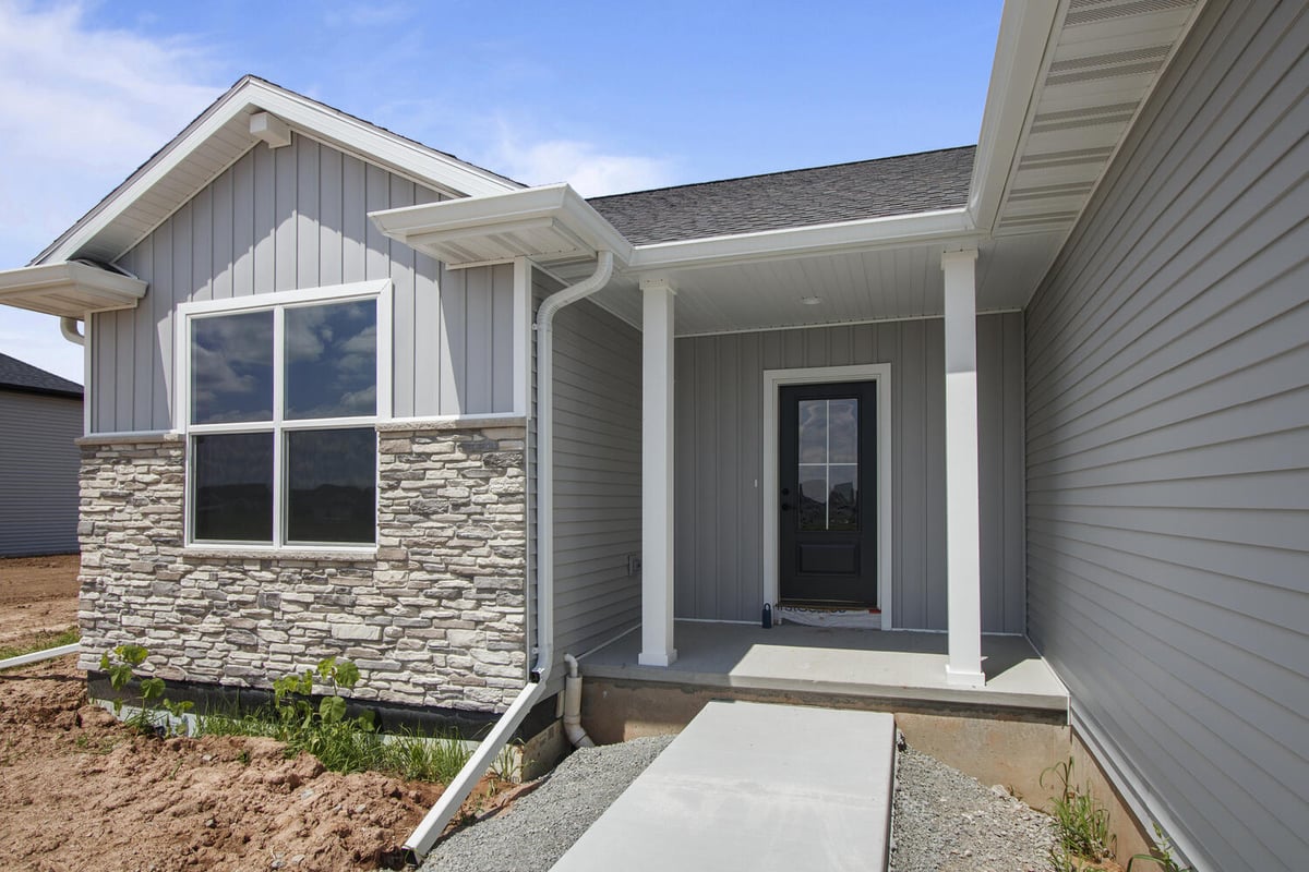 Wisconsin custom home entryway with stone siding by Midwest Design Homes