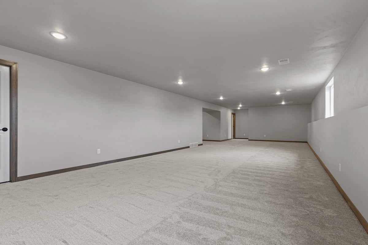Carpeted basement space in a new custom home build by Midwest Design Homes in Harrison, WI