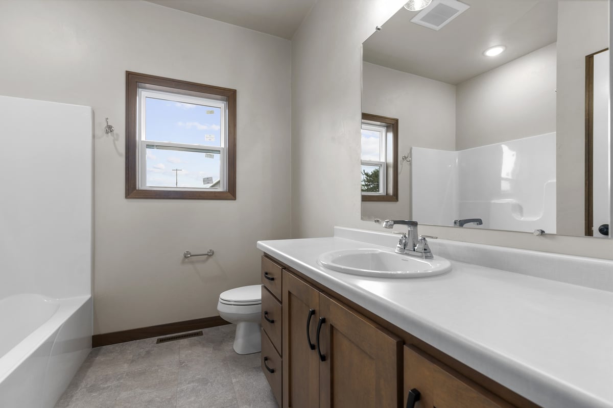 Contemporary bathroom design with clean finishes by Midwest Design Homes in Appleton, WI
