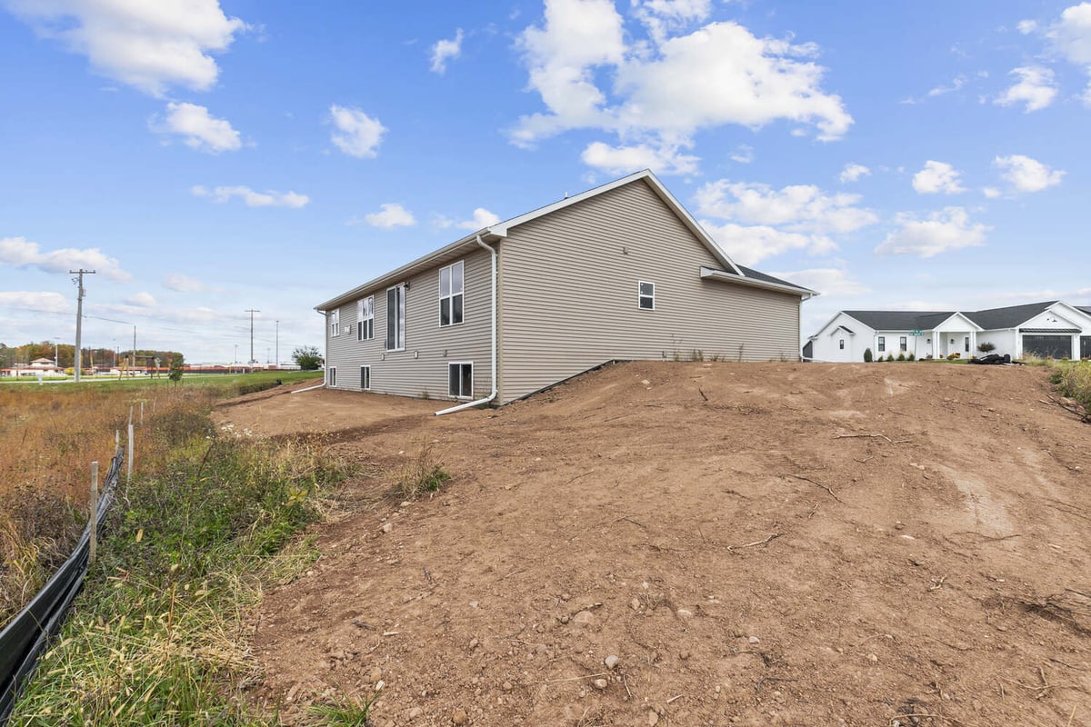 Custom home exterior in Kaukauna WI by Midwest Design Homes with exposed basement