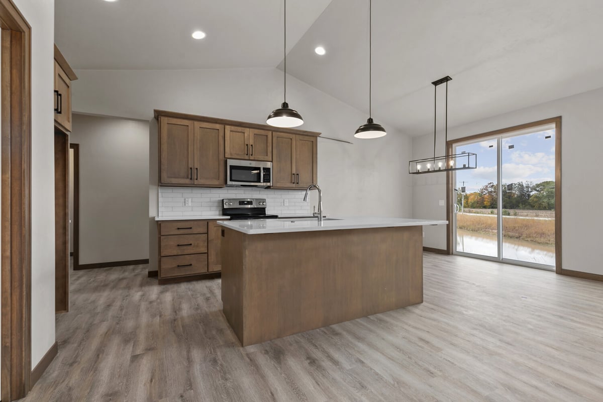 Custom kitchen and dining space with patio door in a Midwest Design Homes home in Neenah, WI