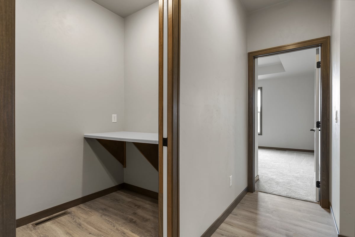 Hallway desk area leading to bedroom in a Midwest Design Homes custom home in Greenville
