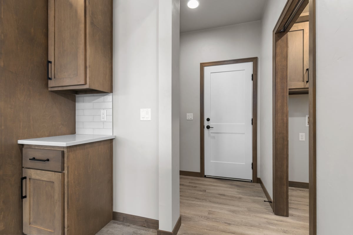 Kitchen corner cabinetry and hallway view in a Midwest Design Homes home in Fox Cities