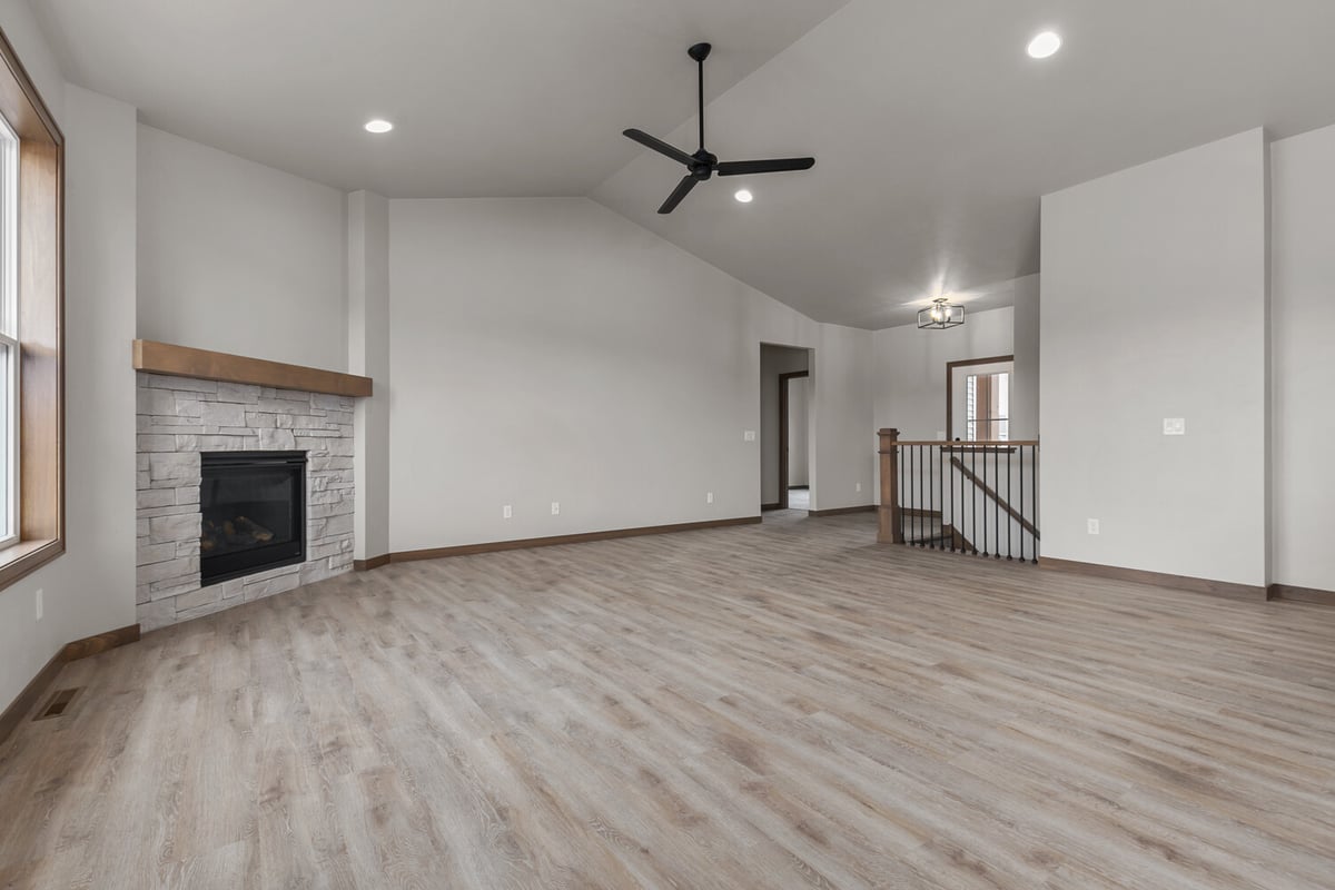 Wide living room with stone fireplace in a Midwest Design Homes custom home in Appleton, WI
