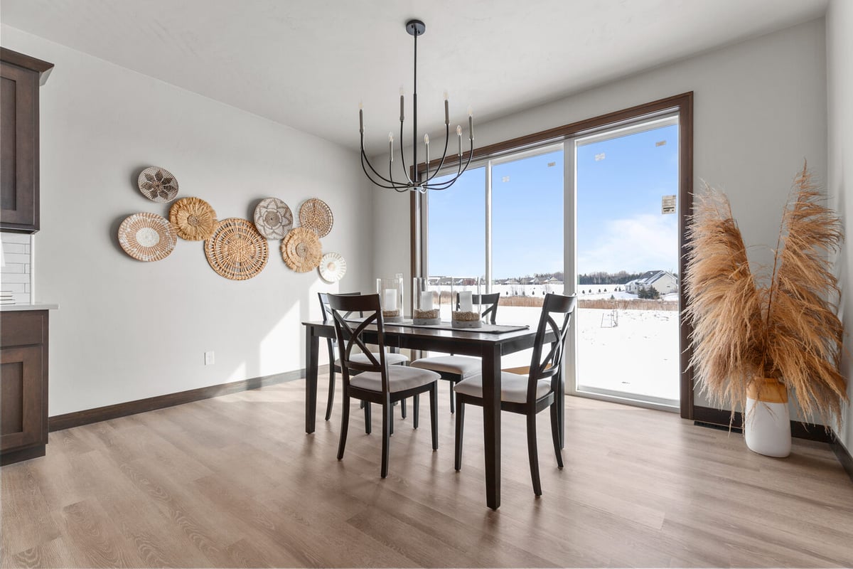 Bright dining area with large windows and views by Midwest Design Homes in De Pere, WI