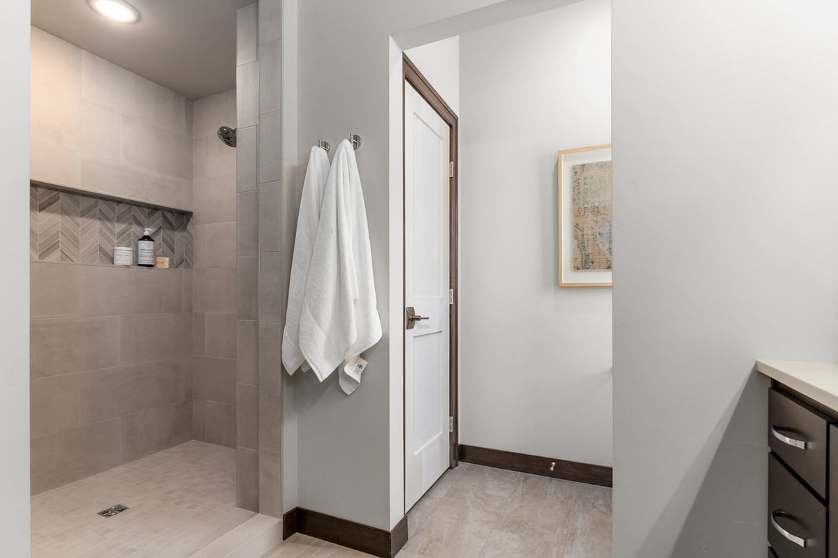 Bright walk-in shower and towel hooks in Kaukauna custom home by Midwest Design Homes