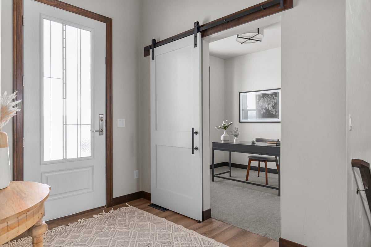 Entryway with sliding barn door by Midwest Design Homes in Appleton, WI