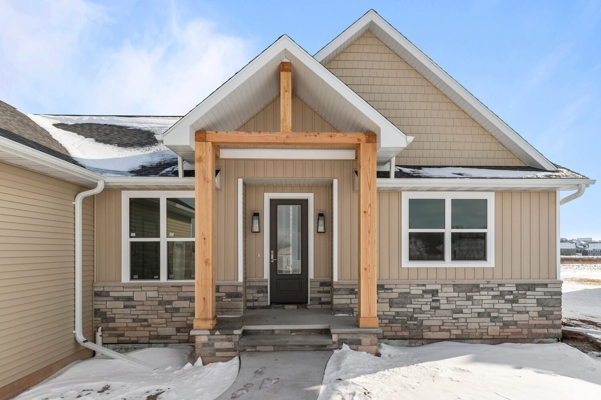Front porch with wood pillars on custom home by Midwest Design Homes in Kaukauna, WI