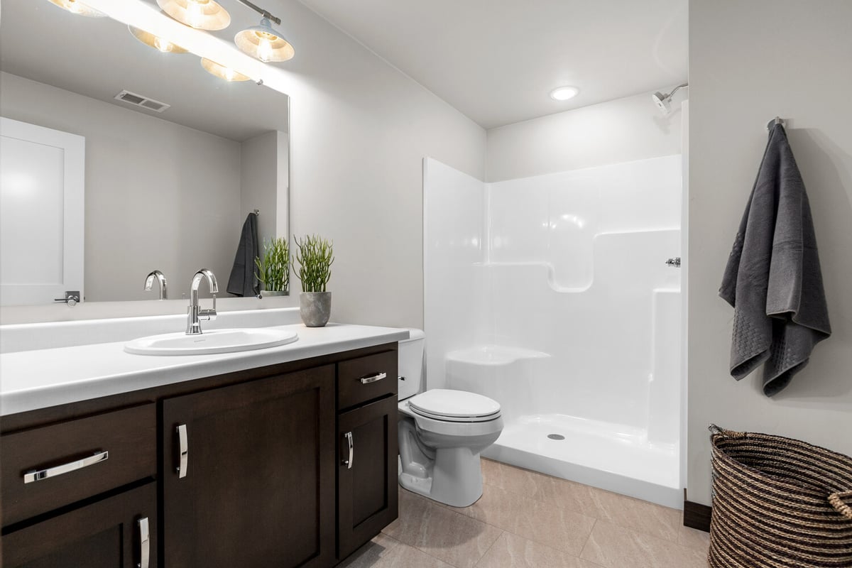 Modern bathroom design by Midwest Design Homes in Kaukauna with walk-in shower and vanity