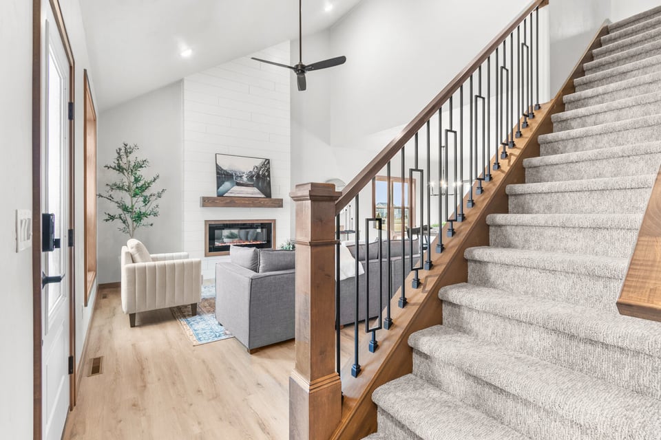 Bright open-concept living room and stairs by Midwest Design Homes in Bellevue, WI
