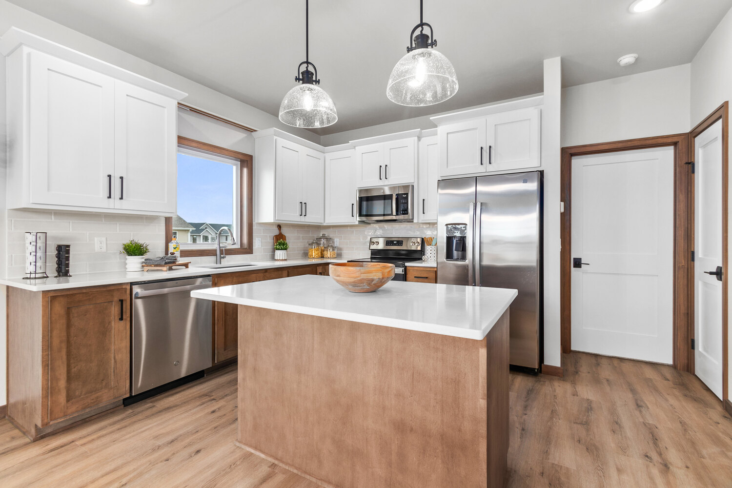 Spacious kitchen with island and custom finishes in De Pere WI home by Midwest Design Homes