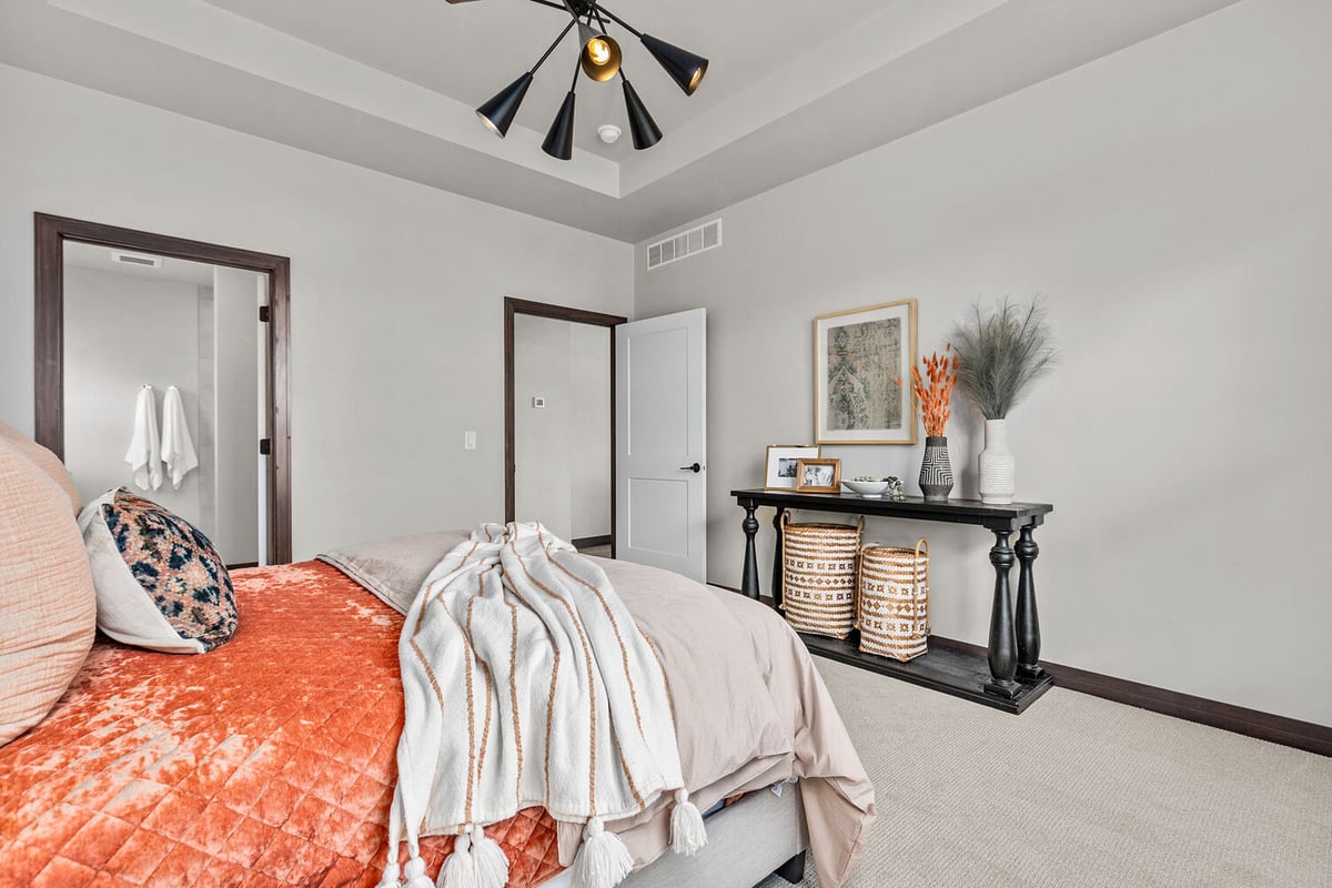 Custom bedroom in Kaukauna, WI by Midwest Design Homes with modern decor and soft tones