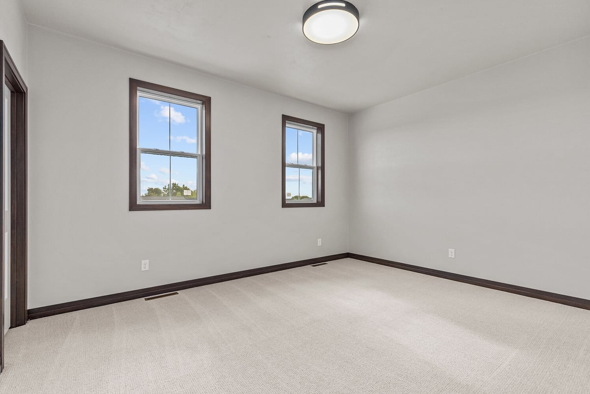 Custom home bedroom with twin windows by Midwest Design Homes in Kaukauna, WI