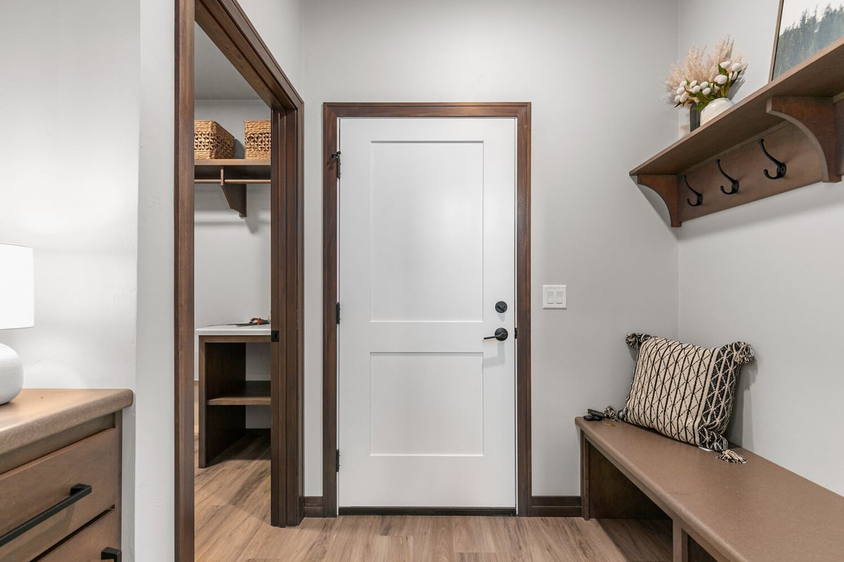 Functional mudroom with bench and hooks by Midwest Design Homes in Kaukauna, WI