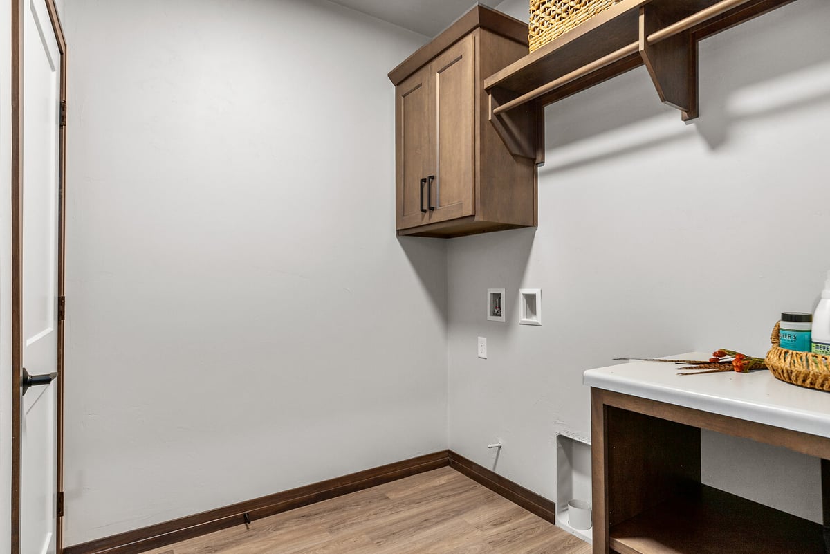 Laundry room setup with upper cabinet in Wisconsin custom home by Midwest Design Homes