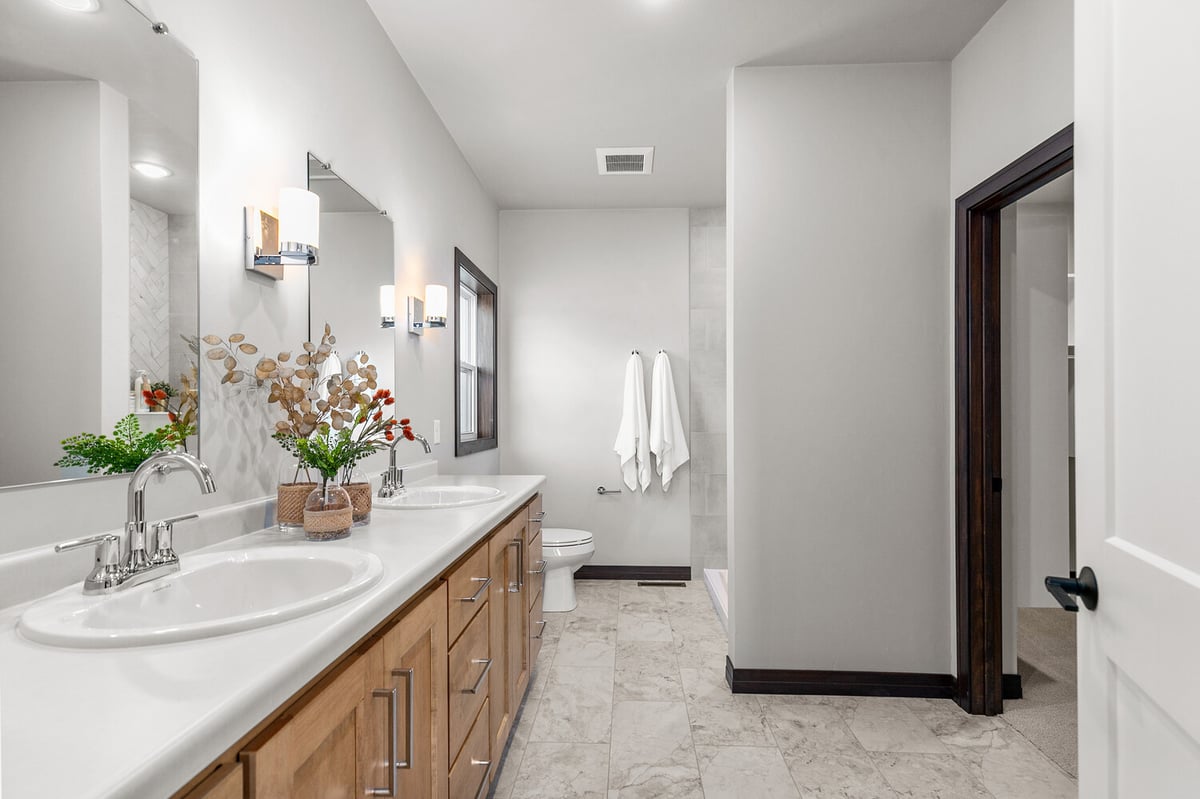 Long view of double vanity bathroom in Midwest Design Homes custom Wisconsin home