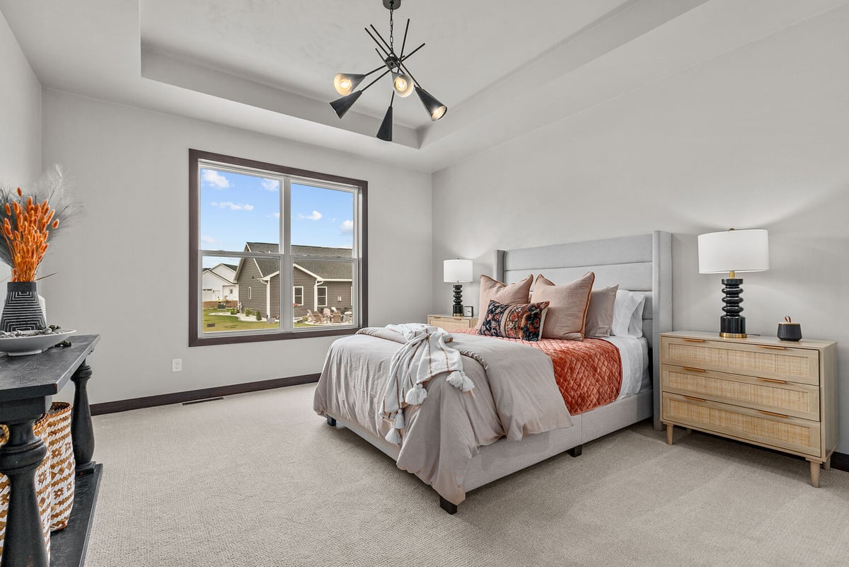 Modern bedroom with large window in Greenville, WI by Midwest Design Homes custom build