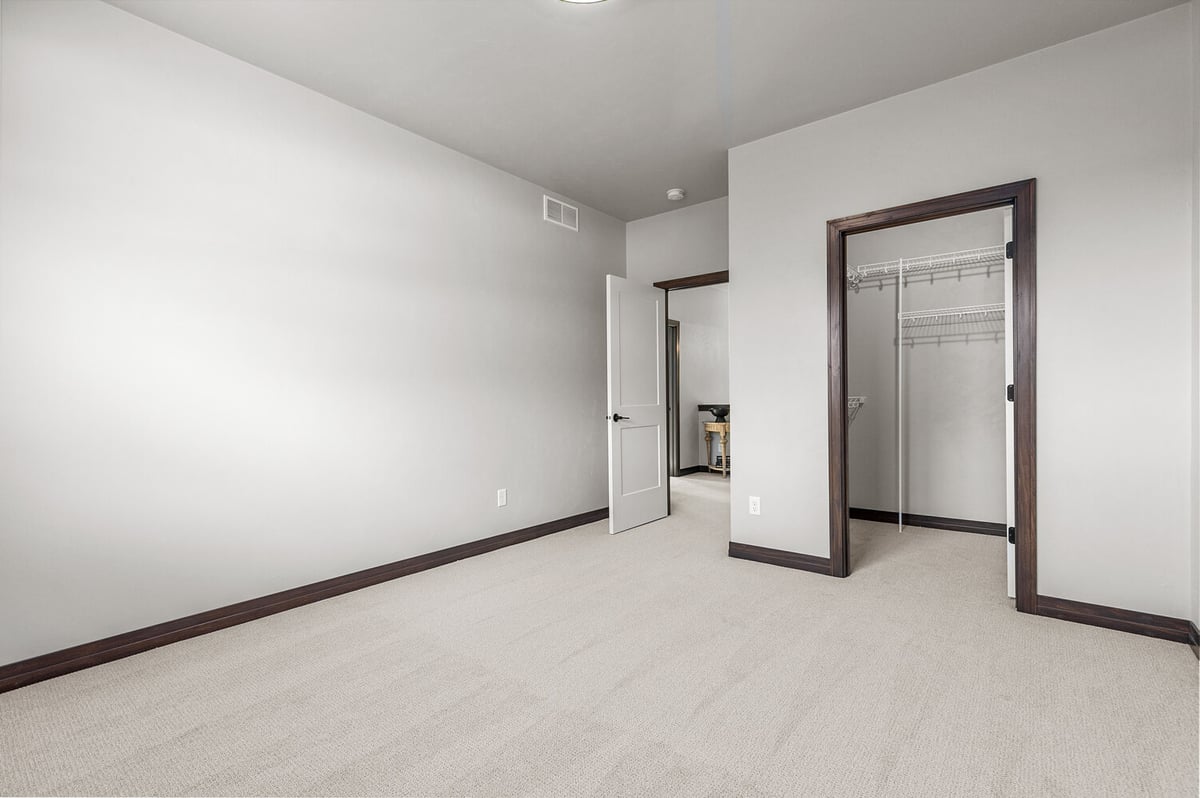 Neutral bedroom with closet in custom home built by Midwest Design Homes in Kaukauna, WI