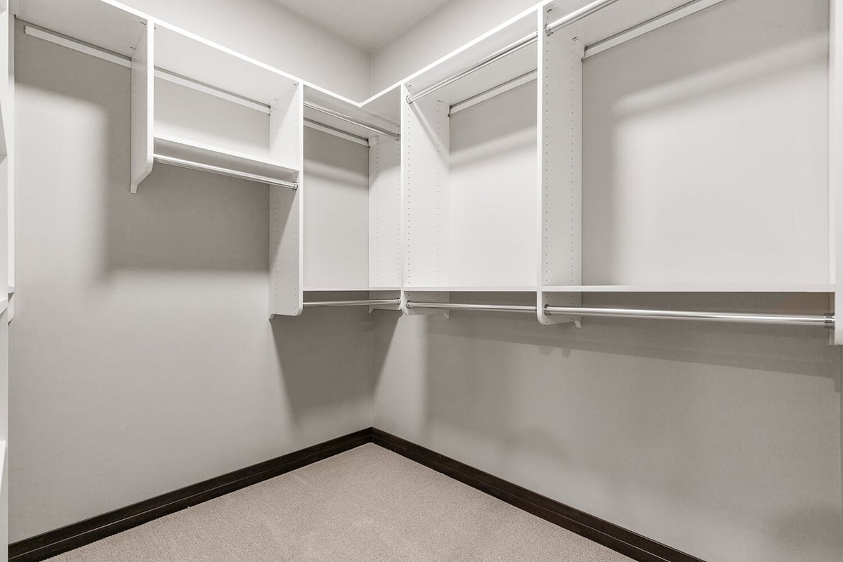 Organized closet space with rods and shelves by Midwest Design Homes in Kaukauna, WI