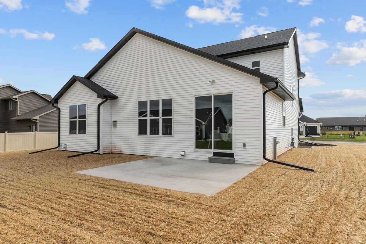 Rear exterior of new Midwest Design Homes custom home in Kaukauna, WI with concrete patio
