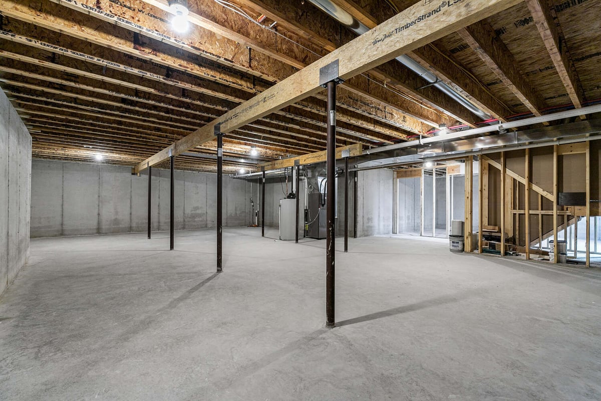 Unfinished basement with exposed ceiling in custom home by Midwest Design Homes