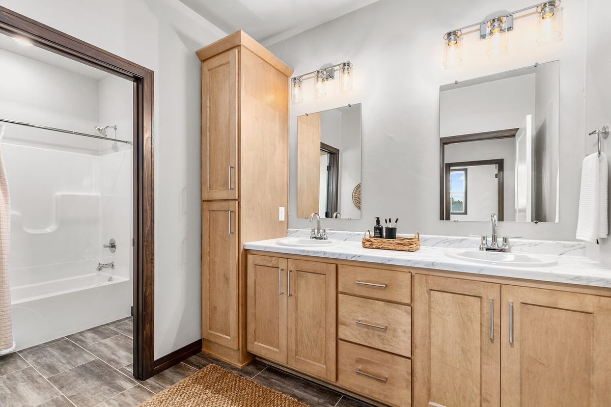 Wide angle of bathroom and shower in custom Wisconsin home by Midwest Design Homes