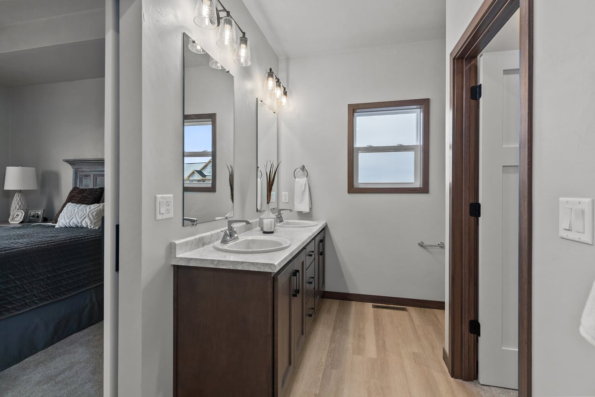 Bathroom view into bedroom in Lawrence, WI home by Midwest Design Homes