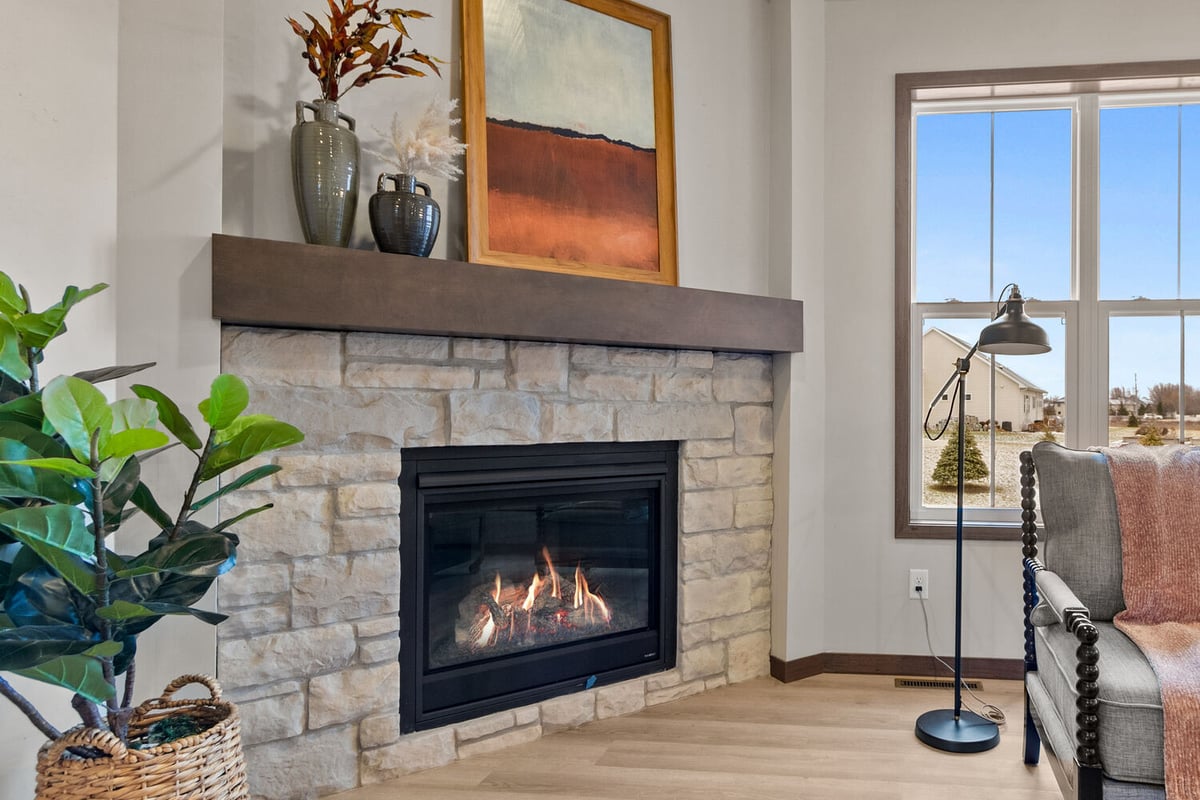 Cozy gas fireplace in Wisconsin living room by Midwest Design Homes, custom home builder