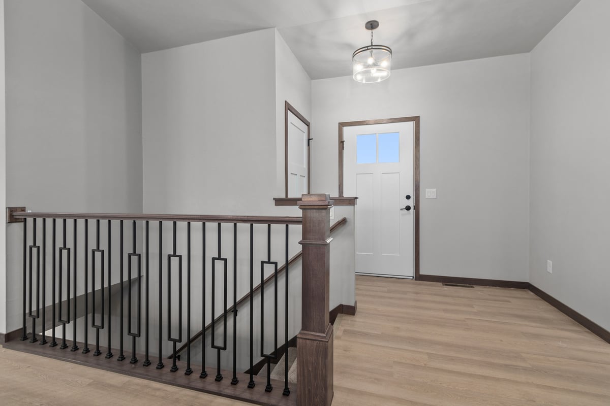 Custom home entryway with modern railing in Green Bay WI by Midwest Design Homes